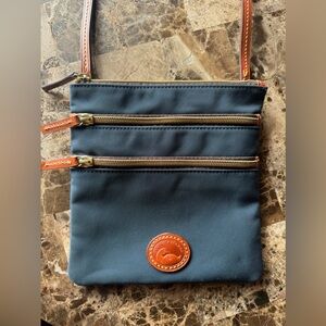 Dooney & Bourke - crossbody messenger bag, navy with brown leather details.